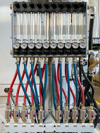 circuit with blue and red hoses connecting graduated test tubes with pressure gauges and temperature...
