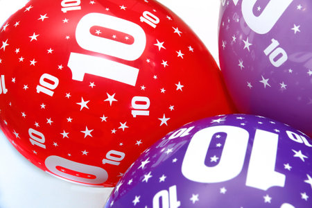 three colorful balloons with stars and the number 10, birthday balloons, red blue and purple, tenth anniversary party, horizontalの写真素材
