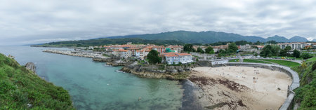 panoramic view of Llanes, Asturias, Spain, with the beach in the foreground, the entrance to the...
