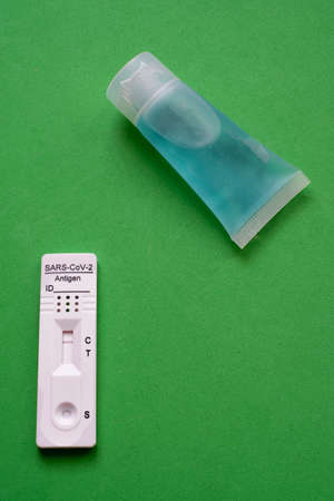 virus antigen test, , sars, , with negative reult, together with a hand disinfection gel on a green...
