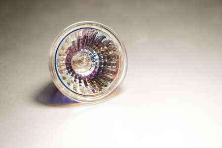 Close up of a halogen spotlight on a blurred surface, selective focus, halogen bulb, 50W, low energy efficiency, copy spaceの写真素材