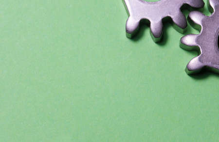 two gears geared on a yellow background with copy space, geared steel sprockets, sprocket,...