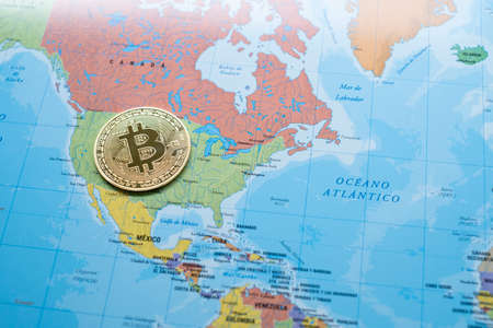 a bitcoin coin on a political map of North America, on the territory of the united states, use of cryptocurrency worldwide, economic power, crypto coint currency, horizontalの写真素材