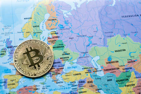 a bitcoin currency on a political map Europe and Asia, next to Ukraine, use of cryptocurrency, aid...