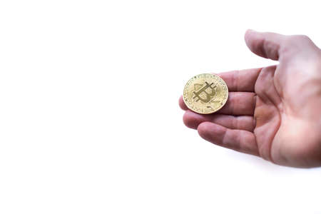 a hand holding a bit coin, as in a position to receive or accept a cryptocurrency as a payment form,...