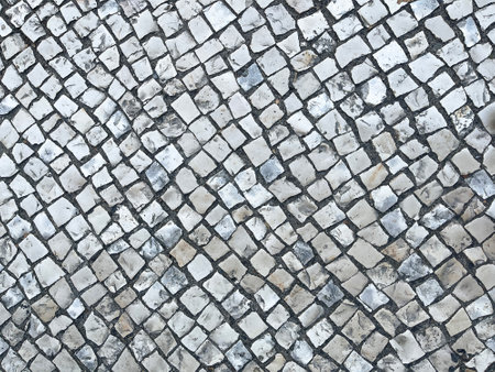Portuguese roadway or Portuguese cobblestone, paving stone texture, mosaic shaped pavement, lisbon street floor, horizontalの写真素材