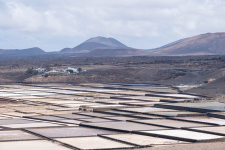 Evaporation ponds or crystallizers pool of the Janubio Salt Flats with the volcanic landscape of the island of Lanzarote in the Canary Islands, horizontalの写真素材