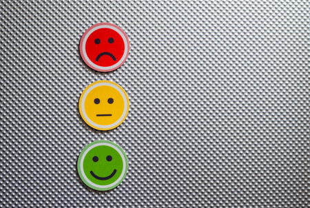 Three round emoji faces in red, yellow, and green representing sad, neutral, and happy emotions on a...