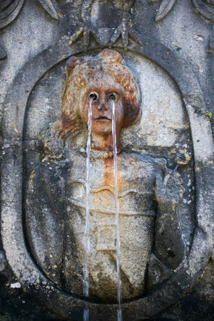 Close-up of the Sight Fountain at the Bom Jesus do Monte stairway in Braga Portugal Water streams from the figures eyes symbolizing the purification of the senses and religious devotionの写真素材