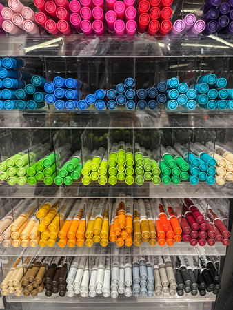 Guadalajara, Spain; December 19 2025: a shelf with compartments filled with colored markers of...