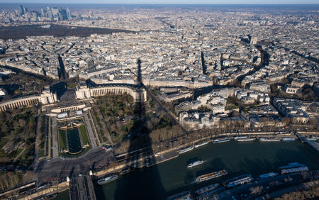 The shadow of the Eiffel Tower over the historic center of Paris, with the Trocadero square and the...