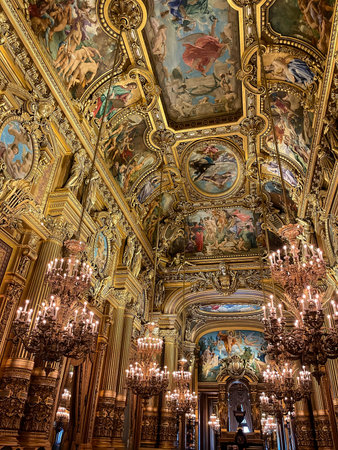 Vertical view of the opulent grand foyer at opera garnier in paris showing golden baroque...