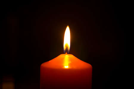 Candle flame in the darknes. Burning candleの写真素材