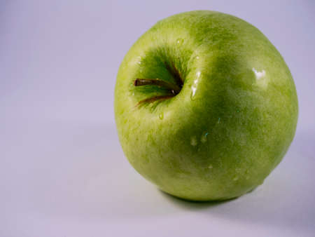 Close-up of green apple on white backgroundの写真素材
