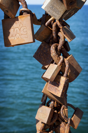Padlocks in a cliff in Salinas, Asturias, Spainの写真素材