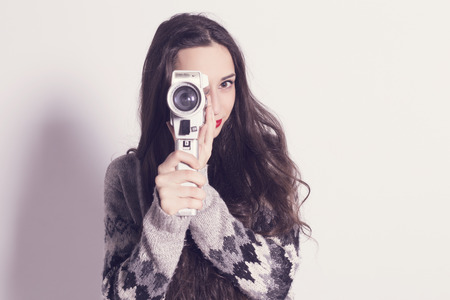 Beautiful modern girl recording with a very old and dirty Super 8mm cameraの写真素材
