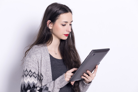 Girl using tablet computer, working on touching screen.の写真素材