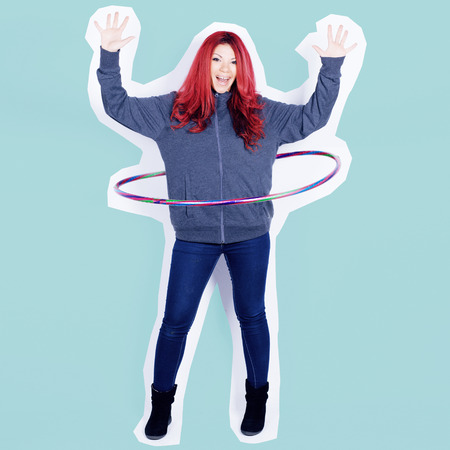 Young redhead woman dancing with a  hoop, over a cyan background, rough outlined.の写真素材