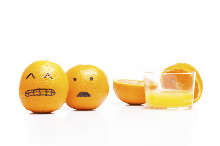 Oranges running away from a glass of juice!. Funny moment.の写真素材