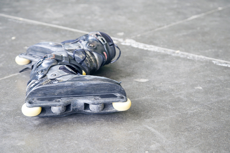 Rollerblading. A pair of very used inline skates on the street.の写真素材