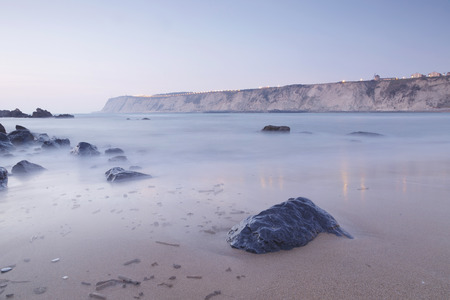Serene seascape in Arrigunaga beach, Biscay, Basque Country, Spain. Long exposure on a misty sunset.の写真素材