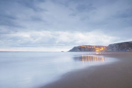 Serene seascape in Arrietara beach, Biscay, Basque Country, Spain. Long exposure on a cloudy sunset.の写真素材