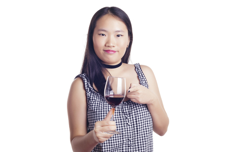 Asian girl with a glass of red wine, over a white background, isolated.の写真素材