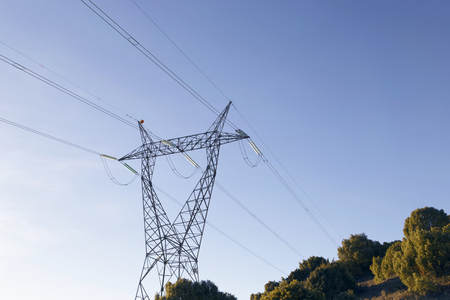 High-voltage power lines. Electricity distribution in La Rioja, Spain. The meadow below. Industry and nature coexist.の写真素材