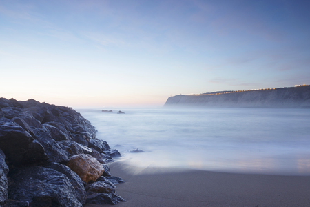 Serene seascape in Arrigunaga beach, Biscay, Basque Country, Spain. Long exposure on a misty sunset.の写真素材