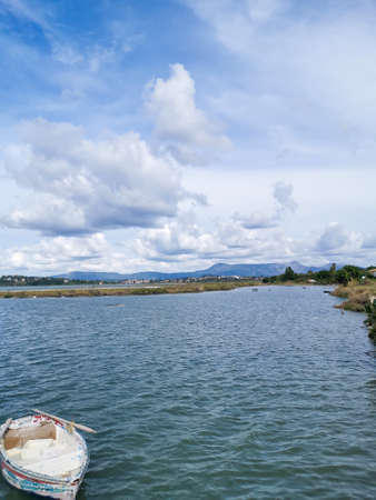white boat on the seashore in Corfuの写真素材