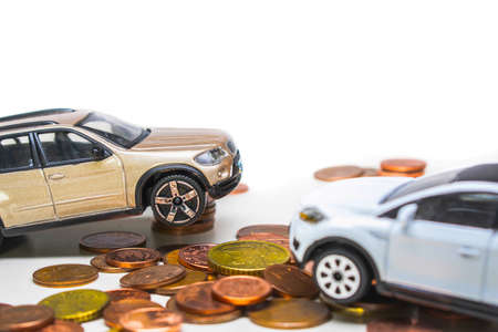 Toy car and coins on a white background.の写真素材