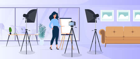 The girl is giving a presentation in front of the camera. The teacher conducts a lesson online. The concept of blogs, online training and conferences. Camera on a tripod, softbox.のイラスト素材