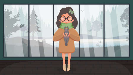 A cute girl is holding a gray cat in her arms. Cartoon style. Vector illustration.のイラスト素材