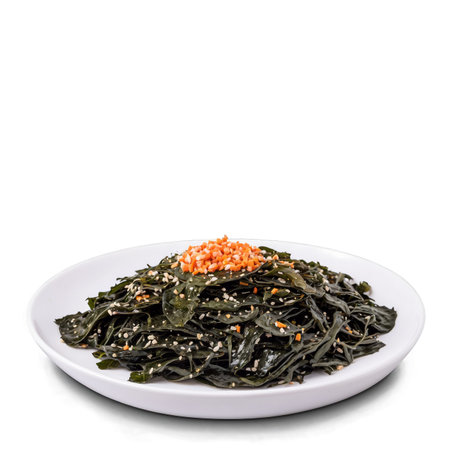 A seaweed salad is displayed on a white plate, sprinkled with sesame seeds and topped with chopped carrots. It looks like a delicious appetizer or side dish, healthy and tasty.の素材