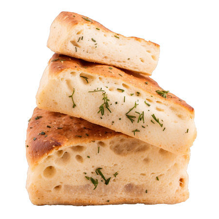 Delicious focaccia bread, cut into pieces and stacked, garnished with fresh herbs. The bread is isolated on a white background, studio shot.の素材