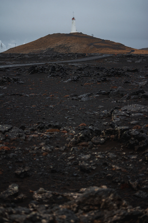 Lighthouse on the hill near the coast in Icelandの写真素材