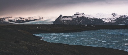 Jokulsarlon, glacier lagoon in Iceland at night with ice floating in water. Cold arctic nature landscape scenery. Ice melting.の写真素材