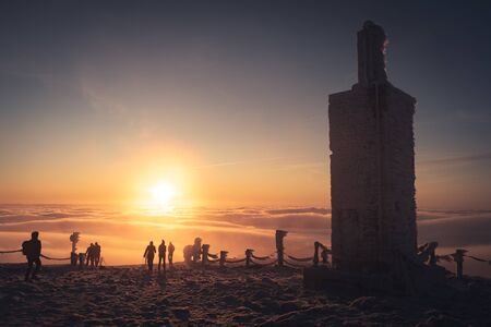 Winter landscape in Krkonose, beautiful sunrise with moon shot from highest mountain in Czech republic called Snezka.の写真素材