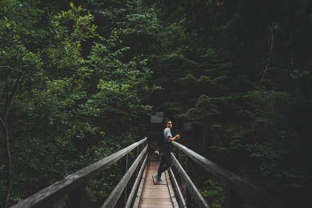 Woman leaning on railing in slovenian wilderness, Triglav national park, Sloveniaの写真素材