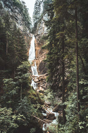 A waterfall, hidden behind hills, deep inside the Martuljek Forest in the Triglav National Park in Slovenia. Its name is Martuljek waterfall-Martuljski slap.の写真素材