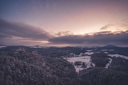 Majestic winter landscape during sunset in Bohemian Switzerland Dramatic wintry scene. Jetrichovice,...
