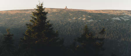 Spring hilly landscape at sunset time. Colorful trees and meadows. View of Krkonose, Pancavske...