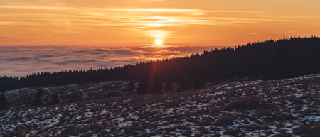 Winter landscape with sunset above mountains in Czech Republic, Giant Mountainsの写真素材