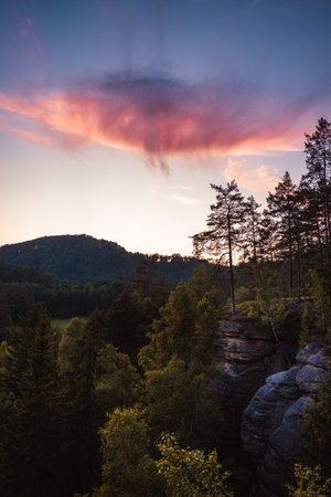 Landscape with purple clouds and forest in foreground, Hrensko, Czech Republicの写真素材