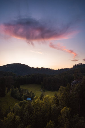 Landscape with purple clouds and forest in foreground, Hrensko, Czech Republicの写真素材