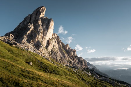 A beautiful mountain stands majestically with a vibrant blue sky serving as the perfect backdrop, creating a stunning natural sceneの写真素材