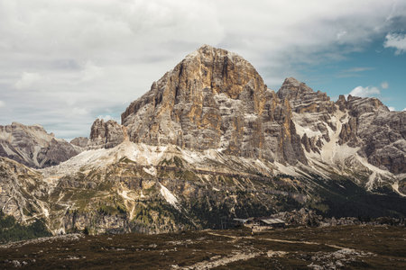 A majestic mountain that is covered with a large number of rocks scattered all over its slopes, showcasing natural beauty and rugged terrainの写真素材