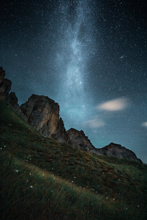 A picturesque starry night sky filled with bright twinkling stars, accompanied by majestic mountains...