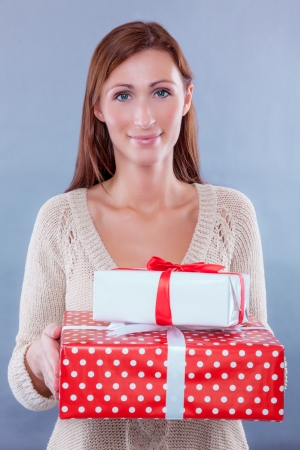 isolated female holding gifts smilingの写真素材