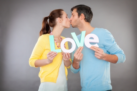 lovers holding letters while kissingの写真素材